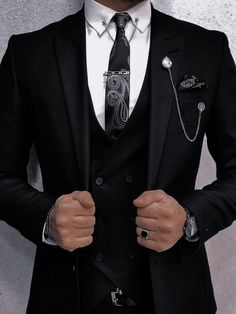 A tuxedo, often referred to as a "tux" in informal contexts, is a formal evening suit distinguished primarily by satin or grosgrain facings on the jacket's lapels and buttons, and a similar stripe along the outseam of the trousers. Traditionally black or midnight blue, the tuxedo is worn with a formal shirt, a bow tie, and patent leather shoes. It is the standard attire for events described as black-tie and is frequently chosen for elegant events, weddings, and sophisticated soirées. Wedding Suits Men Black, Black Suit Wedding, Designer Suits For Men, Men Stylish Dress, Fashion Suits For Men