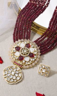 Gold finish necklace with circular floral stone and pearl embellished pendant and multiple maroon beaded strands. Comes with a stone embellished square shaped studs. - Aza Fashions Diana Penty, Luxury Sale, Jewellery Sets, Red Bead, Modern Bride, Bead Strand, Brass Color, Aza Fashion, Gold Finish