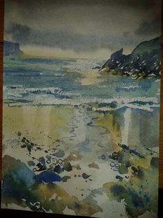 a watercolor painting of the ocean and mountains