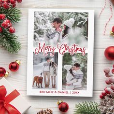 a christmas card with two people and a dog on it, surrounded by holiday decorations