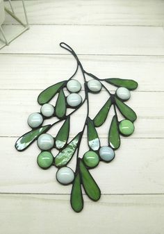 a green and white plant is hanging on the wall