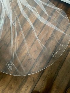 a bride's veil is on the floor with her shoes