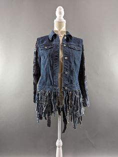 a mannequin wearing a jean jacket with fringes