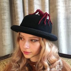 A black bowler hat adorned by a needle felted Red widow spider. The brim is bound in black silk and the crown is finished with a red velvet ribbon. You can order this hat in any color you like for no additional charge. How to measure your head: Use a soft measuring tape and measure around the middle of your forehead above the ears, and at the tightness you are comfortable with. The nature of hand felted wool means that there are many variables that are more or less difficult to control. Your hat Red Widow Spider, Red Widow, Black Bowler Hat, Red Velvet Ribbon, Widow Spider, Larp Costume, Bowler Hat, Derby Hat, Hand Felted