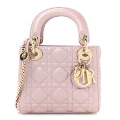 This is an authentic CHRISTIAN DIOR Metallic Lambskin Cannage Mini Lady Dior in Lotus. This small handbag is crafted of leather with a geometric quilted pattern in metallic pink.It features leather handles, an optional shoulder strap, and light gold hardware including handle rings, clasps, decorative eyelets, and a hanging Dior" letters charm. The top is secured by an interior flap and opens to a pink Dior logo-jacquard weave fabric with a zipper pocket. Pink Quilted Leather Bag, Elegant Pink Quilted Shoulder Bag, Formal Pink Quilted Shoulder Bag, Elegant Quilted Pink Bag, Pink Quilted Evening Bag, Designer Leather Shoulder Bag With Diamond Quilting, Chic Top Handle Bag With Diamond Quilting, Pink Dior, Mini Lady Dior