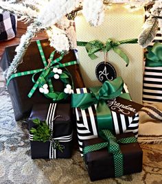 several presents wrapped in black and green ribbons