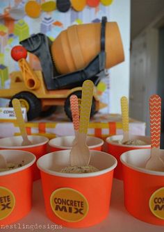 orange cups filled with ice cream and straws