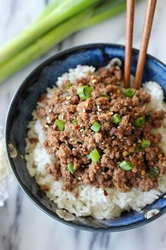 a blue bowl filled with rice and meat