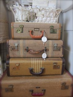 four suitcases stacked on top of each other