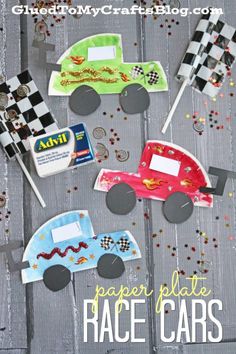 paper plate race cars are displayed on a wooden surface with checkered flags in the shape of racing cars