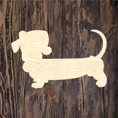 a wooden cutout of a dog on a wood background with the word dachshund