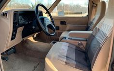 the interior of a vehicle with beige leather seats