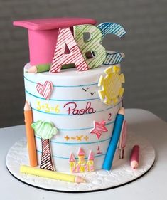 a cake that is decorated with pencils and erasers on top of the cake