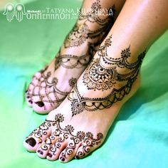 the feet are decorated with henna tattoos