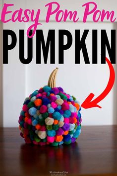 an easy pom pom pumpkin made out of pom poms on top of a table