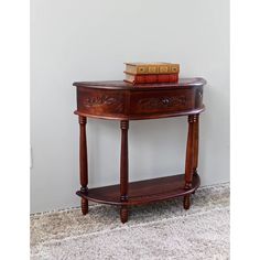 a table with a book on top of it next to a white wall and carpet