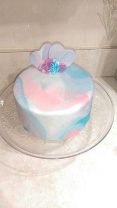 there is a cake that has been decorated with blue and pink icing