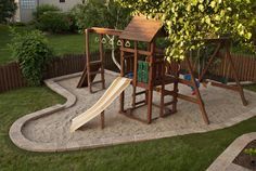 a wooden swing set and slide in a backyard