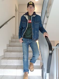 an older man standing on the stairs with his hands in his pockets