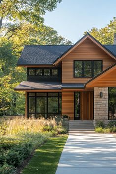 a large house with lots of windows and wood trimmings on the front door