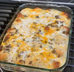 a casserole dish sitting on top of an oven rack covered in cheese and meat