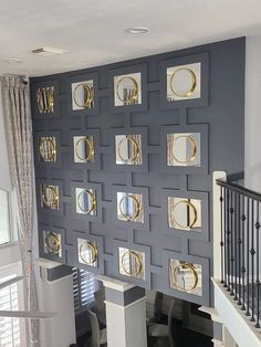 the wall is decorated with gold and silver circles on it's sides, along with white stairs