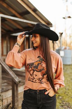 Ride into the Wild West with our Cowboy Rider Graphic Sweatshirt. Featuring trendy balloon sleeves and crafted on French Terry for an unmatched level of comfort, this sweatshirt effortlessly combines fashion and coziness. The standout cowboy rider graphic adds a rugged charm to your casual wardrobe, making it a must-have for those who crave a uniquely designed top. Country Style Tops For Fall Rodeo, Oversized Long Sleeve Tops For Outdoor, Western Tops For Rodeo In Fall, Western Style Tops For Rodeo In Fall, Country Style Crew Neck Top For Rodeo, Trendy Long Sleeve Tops For Outdoor, Western Style Crew Neck Tops For Fall, Western Long Sleeve Tops For Outdoor, Trendy Oversized Tops For Rodeo