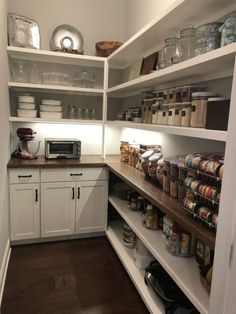 an organized pantry with lots of food items on the shelves and cupboards in it