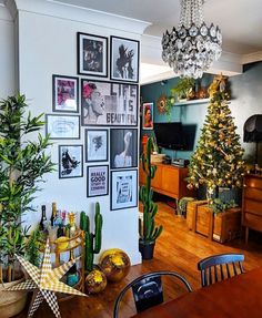 a living room filled with lots of furniture and christmas decorations on the wall next to a tree