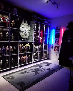 a room filled with star wars action figures and lights on the walls, along with a large area rug