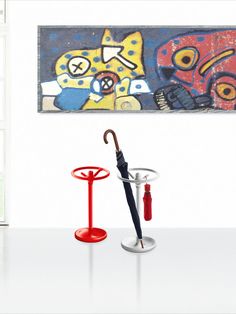 an umbrella and stand in front of a painting