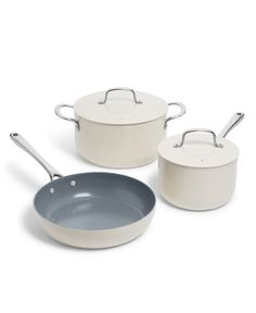 three white pots and pans with lids