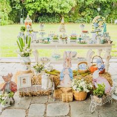 a table filled with lots of different types of decorations on top of hay bales