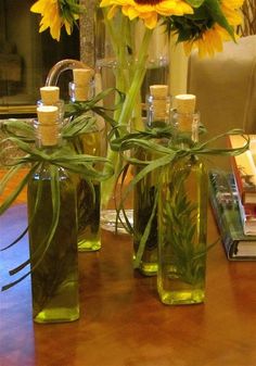 three vases filled with yellow flowers on top of a wooden table