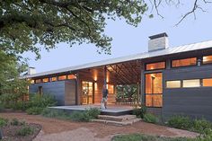 a man standing in front of a modern house