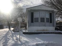 a small house with snow on the ground