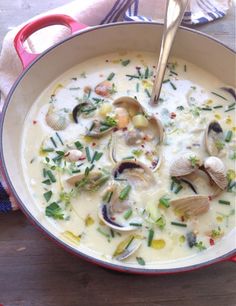 a bowl of clam chowee on a wooden table