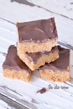 five pieces of chocolate peanut butter bars stacked on top of each other