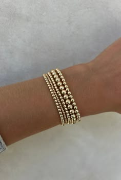 This curated stack consists of a mixture of 5 signature bracelets. (1) 2MM Yellow Gold Filled Beaded Bracelet (2) 3MM Yellow Gold Filled Beaded Bracelets (1) 4MM Yellow Gold Filled Beaded Bracelet  (1) 5MM Yellow Gold Filled Beaded Bracelet DETAILS: 14k Yellow Gold Non-tarnish & water safe Size: 5.75-8", XXS-XXXL 6 Gold Filled Bracelet Stack, Gold Beaded Bracelets Stack, Gold Stack Bracelets, Gold Bead Bracelet Stack, Gold Bracelet Stack, Gold Beaded Bracelets, Jewelry Mood Board, Gold Bracelets Stacked, Jewelry Stack