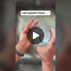 a person holding a glass in front of a metal sink with the caption last quarter moon