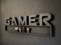 the name gamer is made out of metal letters with skulls on each letter,