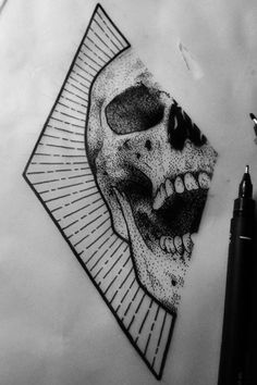 a drawing of a skull on paper next to a pen and ink roller with the image of a person's face