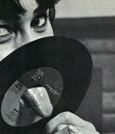 a man holding up a record in front of his face