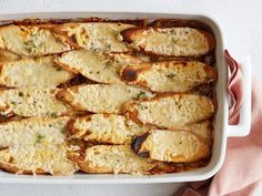 a casserole dish filled with breaded chicken and parmesan cheeses