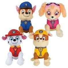 three stuffed animals that are sitting next to each other on a white surface with one dog wearing a fireman's hat