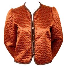 Copper, silk matelasse quilted jacket with decorative metallic gold trim and glass buttons designed by Yves Saint Laurent dating to 1979 as seen on the fall runway. French size 40 however this runs small and would better fit a modern FR 36 or 38. Approximate measurement: shoulder 14", bust 38", arm length 24" and overall length 19". Fully lined. Button closure. Made in France. Very good condition. 1970s Jacket, Fall Runway, Floral Coat, Leather Blazer Jacket, Vintage Ysl, Designer Jackets, Safari Jacket, Rive Gauche, Velvet Jacket