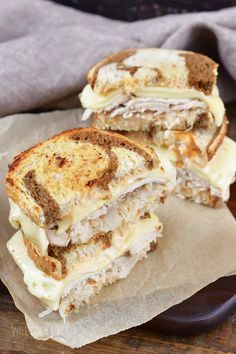 grilled cheese sandwich cut in half on wax paper