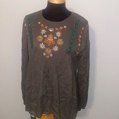 This Cute Top Has Front Embroidery And Lace. It Has Long Sleeves With Elastic Around The Bottom. The Back Is An Open Back With A Top Button Closure. Cam Be Dressed Up Or Down! Armpit To Armpit Is 22 Inches And Length Is 27 Inches. It Is An Oversized Fit So A Size Large Could Wear, Too Green Floral Embroidered Tops For Fall, Embroidered Green Blouse For Fall, Green Floral Embroidery Tops For Fall, Multicolor Embroidered Top With Geometric Patterns For Fall, Multicolor Geometric Embroidered Top For Fall, Long Sleeve Cotton Top With Tonal Embroidery, Green Long Sleeve Top With Embroidered Neckline, Green Long Sleeve Tops With Embroidered Neckline, Green Long Sleeve Top With Intricate Embroidery