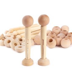 two wooden pegs and several wood beads on a white background