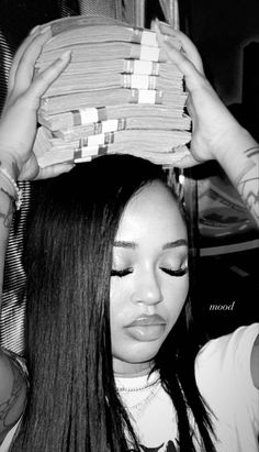 a woman with long hair holding a basket over her head